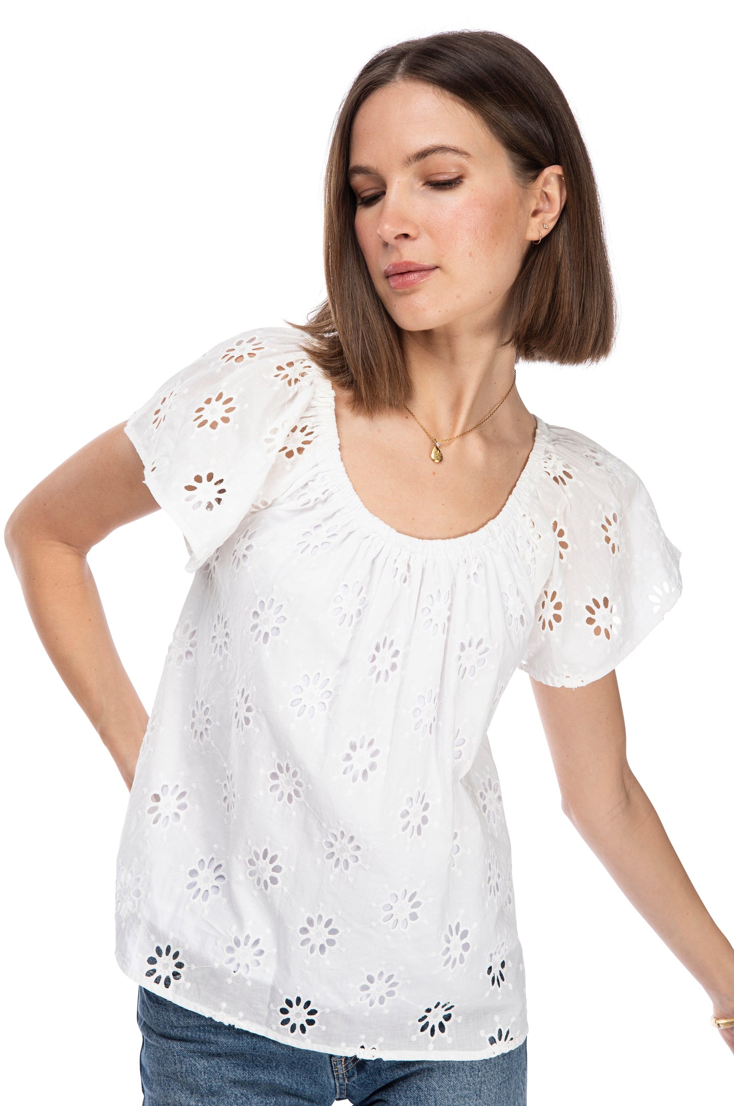 A woman posing with her hand on her hip, wearing a B Collection by Bobeau SS PEASANT TOP.