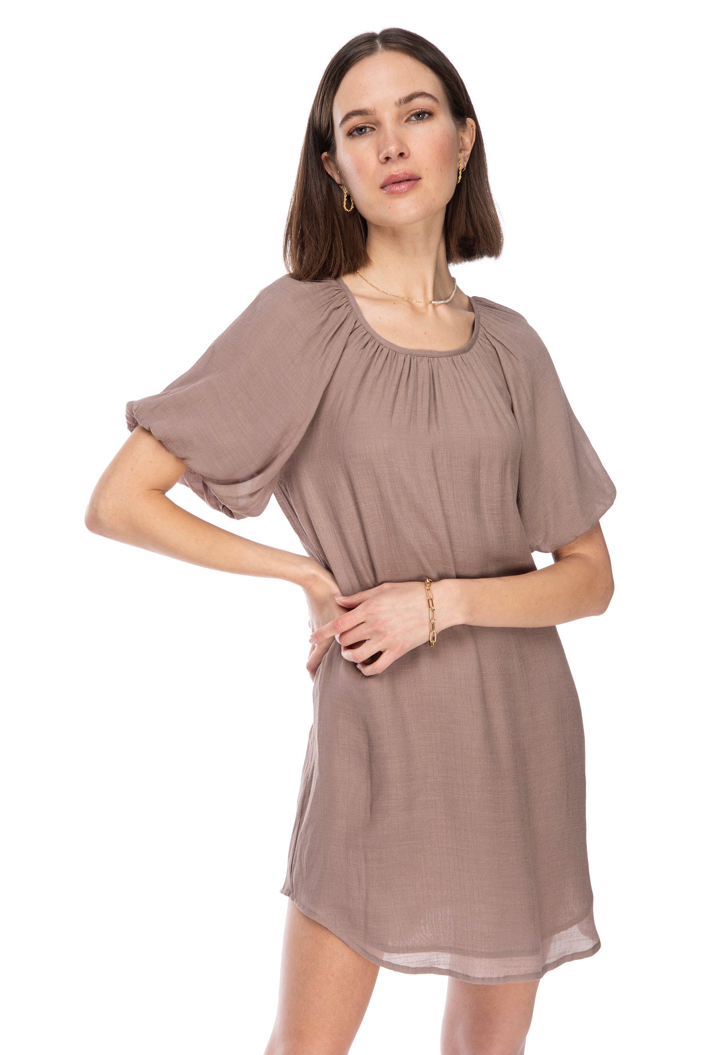Woman in a chic taupe BUBBLE SLEEVE DRESS from B Collection by Bobeau posing with hand on hip.