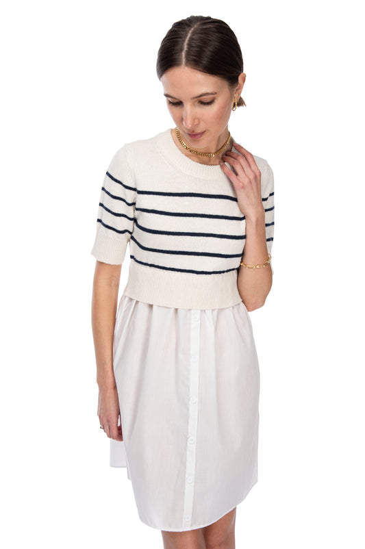 Woman in a chic B Collection by Bobeau mixed media striped sweater vest and white poplin skirt posing against a neutral background.