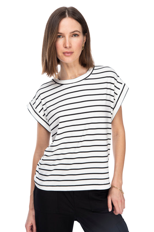 A woman posing in a casual Drop Armhole Tee from B Collection by Bobeau with a relaxed fit and stylish short sleeves.