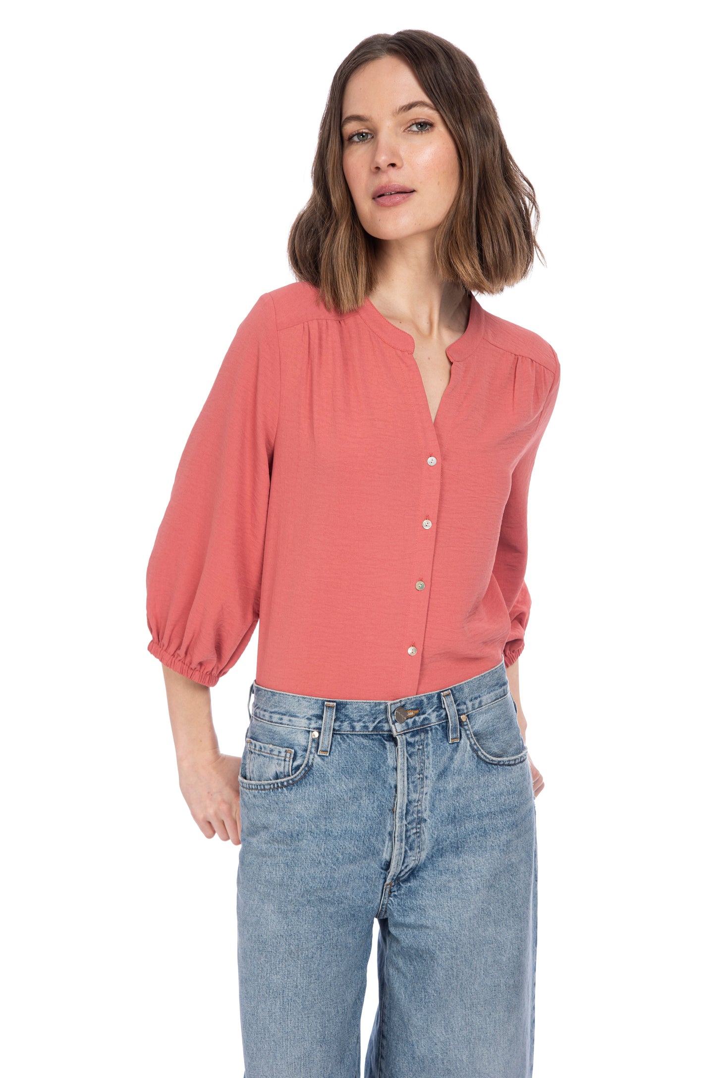 Woman in casual B Collection by Bobeau River Button Up Blouse and blue jeans posing against a white background.