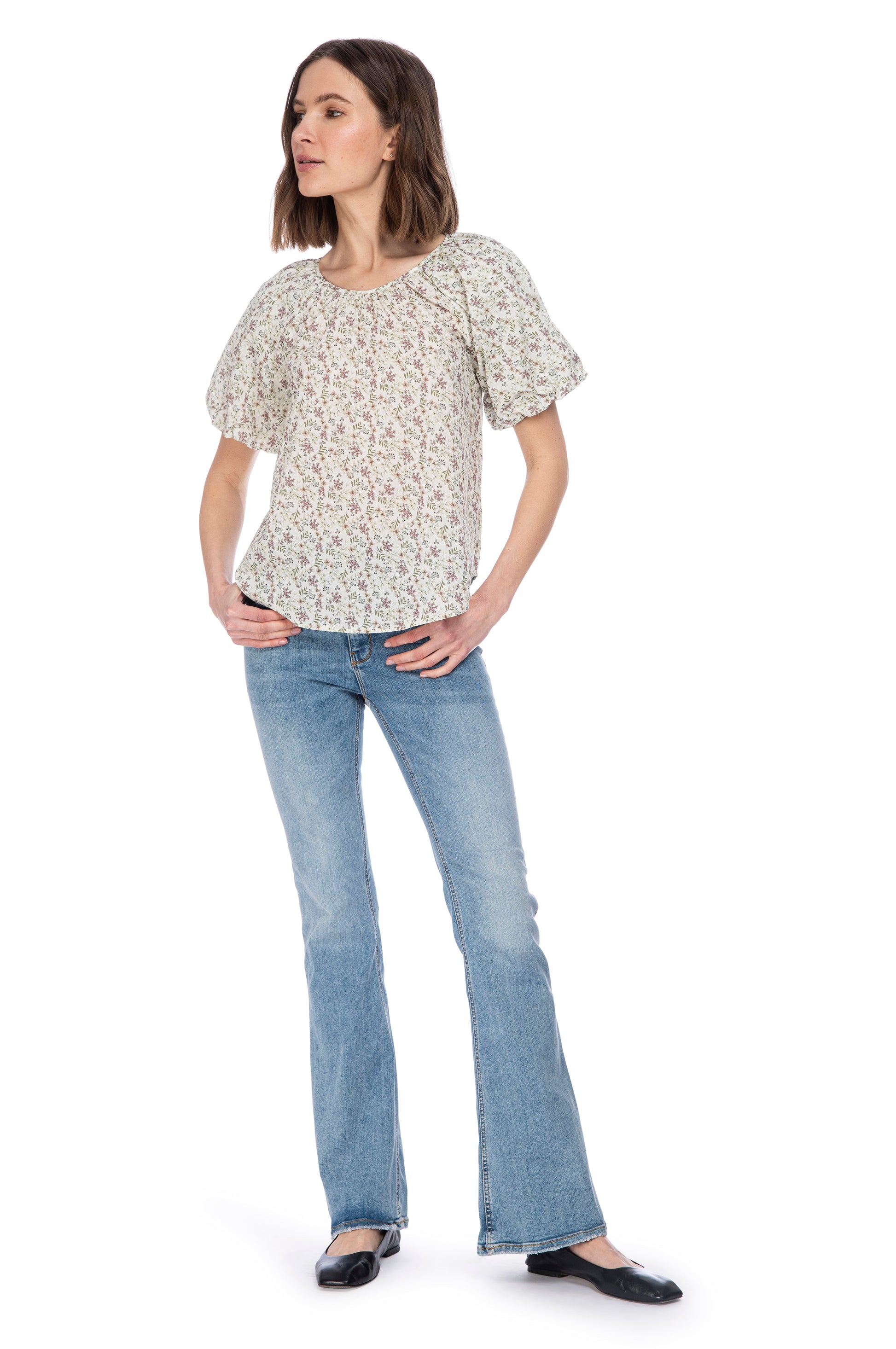 Woman posing in casual attire with a crewneck Bubble Sleeve Cotton Top from B Collection by Bobeau featuring elastic sleeves, blue jeans, and black flats against a white background.