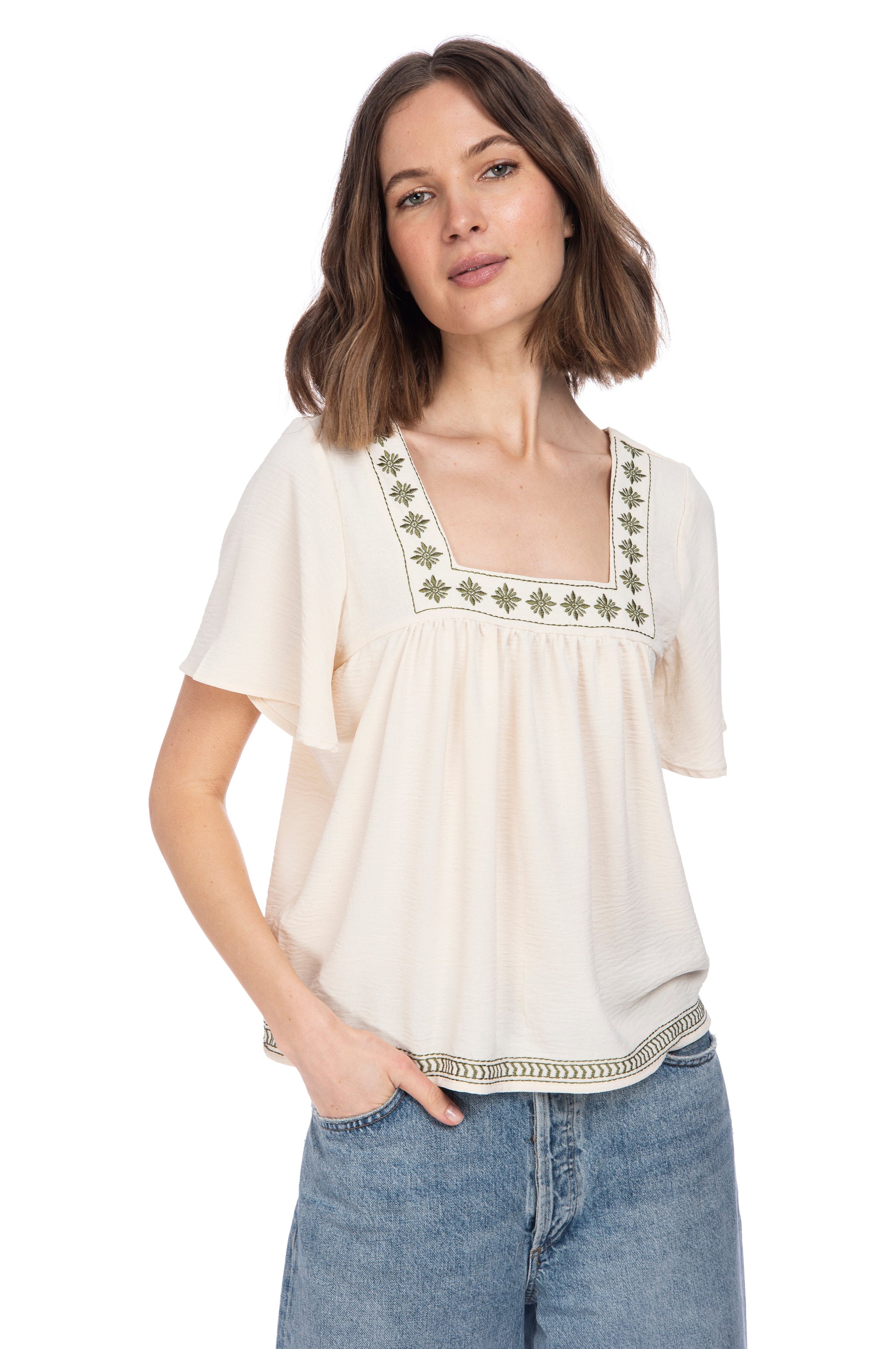 A woman posing for a picture in a SQUARE NECKLINE BOHO TOP with embroidery detail by B Collection by Bobeau.